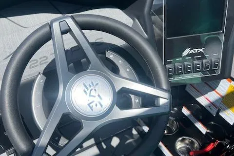 Slide: The Image of 2024 ATX Surf Boats 22 Type-S steering wheel and dashboard controls. - 11