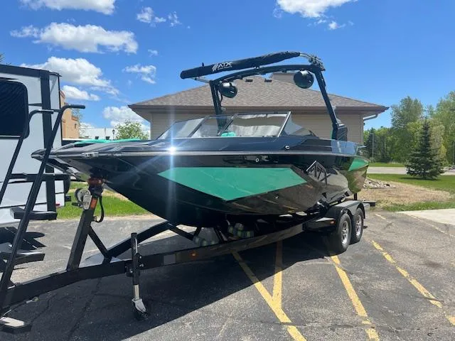 Slide: The Image of 2024 ATX Surf Boats 22 Type-S on trailer, green and black design, parked outdoors. - 4