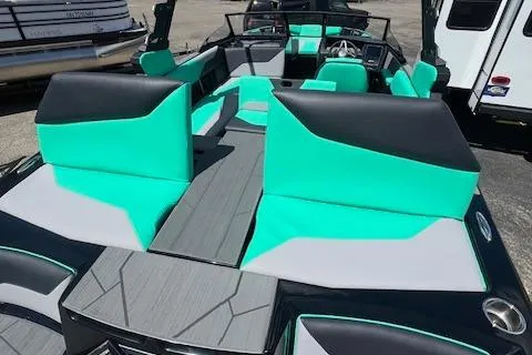 Slide: The Image of 2024 ATX Surf Boats 22 Type-S interior with teal and gray seating. - 9