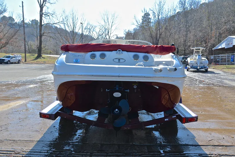 Slide: The Image of 2014 Tahoe Q5 boat on trailer, rear view, outdoors in a parking area. - 13