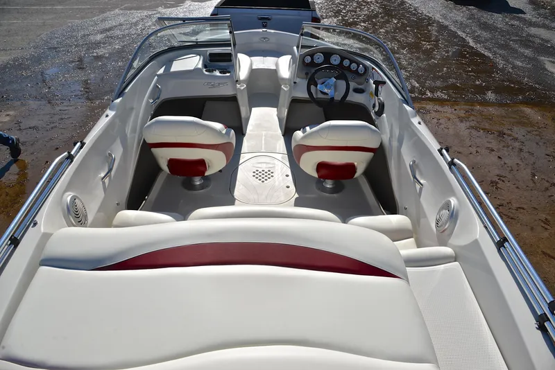 Slide: The Image of 2014 Tahoe Q5 boat interior with white and red seating, dashboard, and steering wheel. - 18