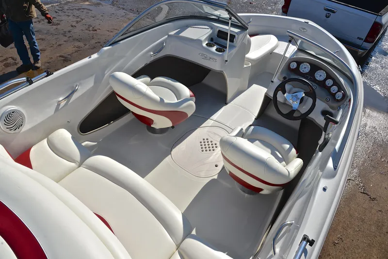 Slide: The Image of 2014 Tahoe Q5 boat interior with white and red seating, steering wheel, and dashboard. - 19