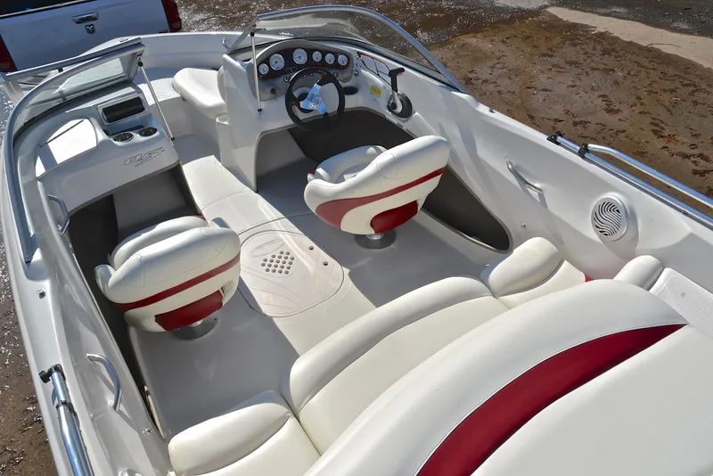 Slide: The Image of 2014 Tahoe Q5 boat interior with white and red seating, steering wheel, and dashboard controls. - 23