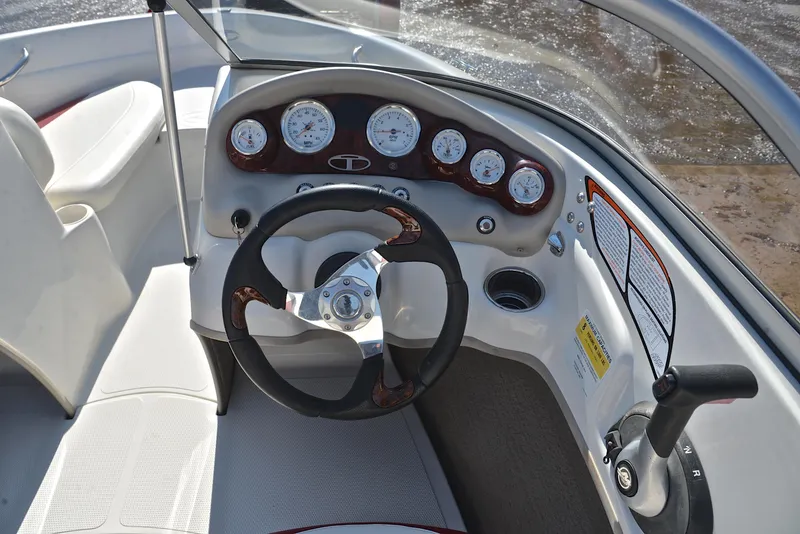 Slide: The Image of Steering console of a 2014 Tahoe Q5 boat with gauges and controls. - 25
