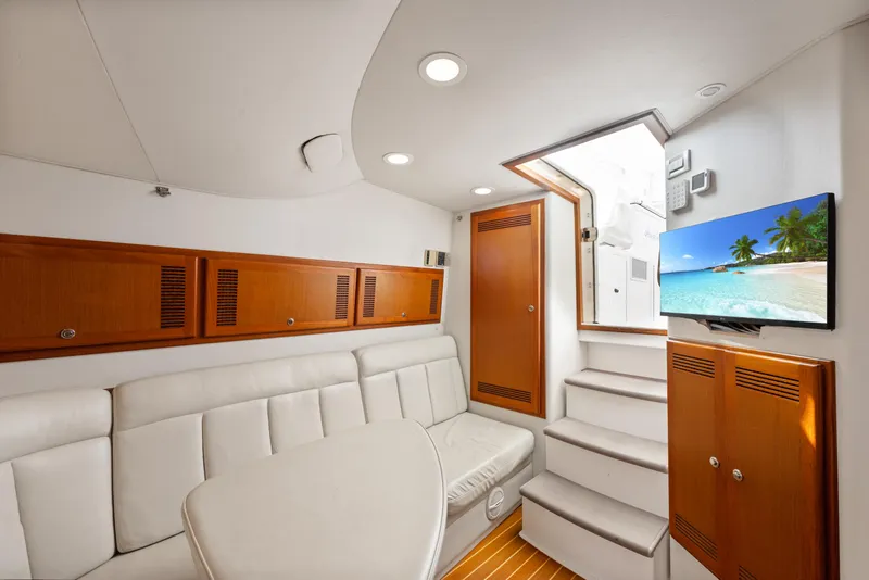 Slide: The Image of Luxurious interior of 2004 Cabo 40 Express yacht with white seating and wooden accents. - 19