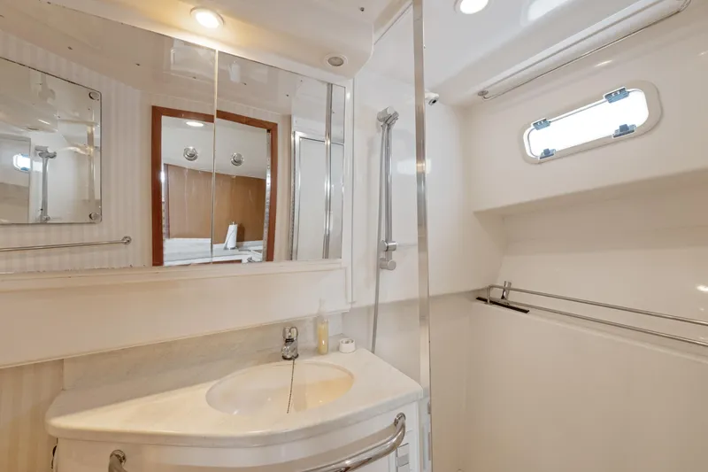 Slide: The Image of Luxurious bathroom in 2004 Cabo 40 Express yacht with modern fixtures and elegant design. - 22