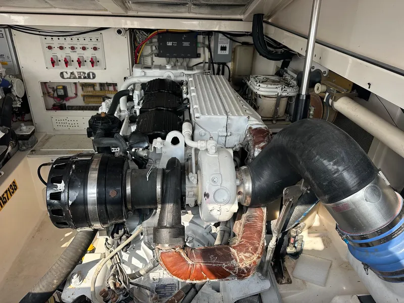 Slide: The Image of Engine room of a 2004 Cabo 40 Express boat, showcasing detailed machinery and components. - 24