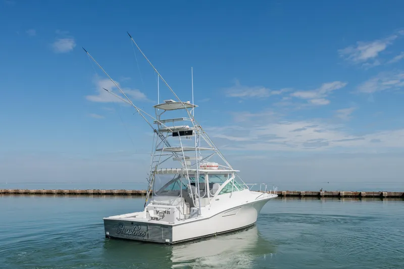 Slide: The Image of 2004 Cabo 40 Express boat on calm water under a clear blue sky. - 3
