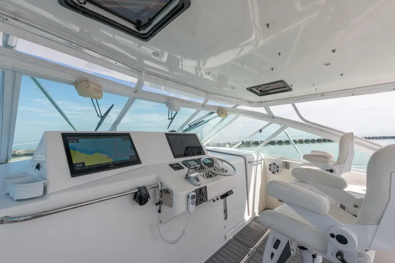 Slide: The Image of 2004 Cabo 40 Express yacht cockpit with navigation equipment and ocean view. - 8