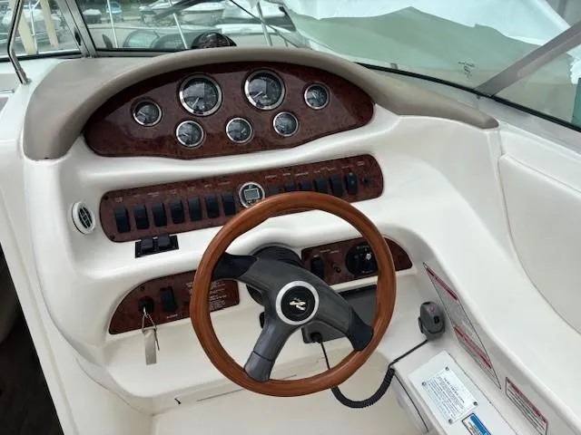 Slide: The Image of Steering console of a 2000 Sea Ray 280 SS boat with wood accents and gauges. - 10