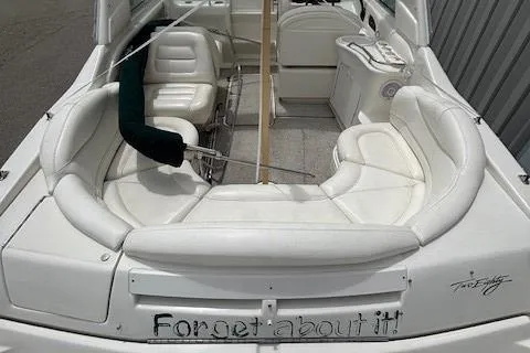Slide: The Image of 2000 Sea Ray 280 SS boat interior with white seating and "Forget about it" text. - 11