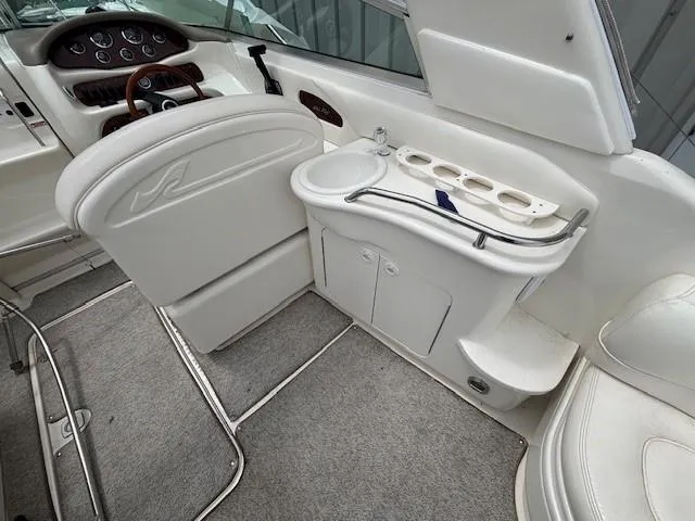 Slide: The Image of Interior of a 2000 Sea Ray 280 SS boat, featuring helm and seating area. - 5