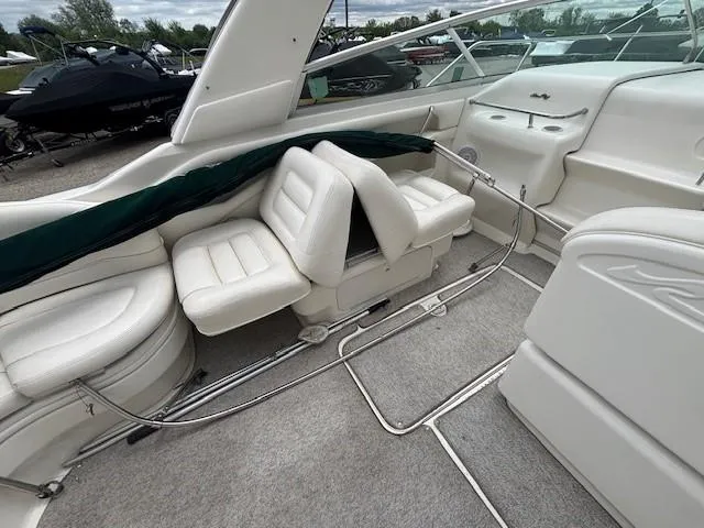 Slide: The Image of 2000 Sea Ray 280 SS boat interior with white leather seating and sleek design. - 6