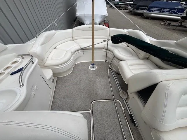 Slide: The Image of 2000 Sea Ray 280 SS boat interior with white seating and carpeted floor. - 7