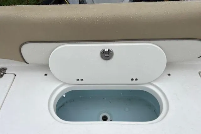 Slide: The Image of 2020 Key West 239 FS boat livewell with beige seating and white lid. - 11