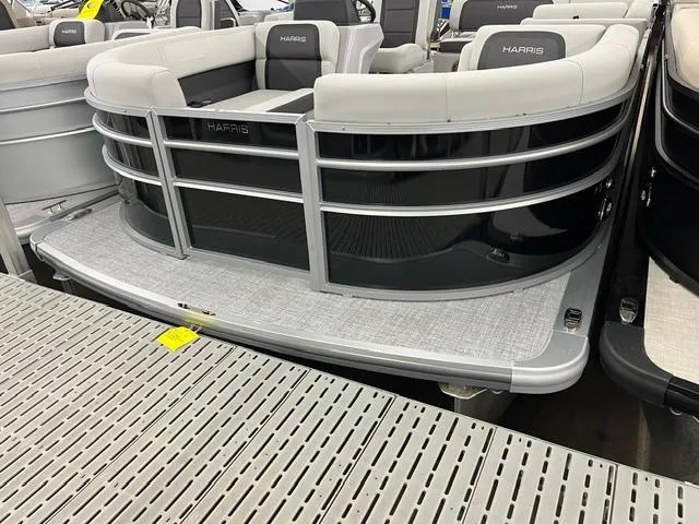 Slide: The Image of 2024 Harris Cruiser 210 pontoon boat with sleek design and comfortable seating. - 1