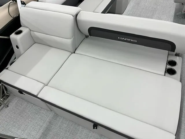 Slide: The Image of 2024 Harris Cruiser 210 boat interior with gray cushioned seating and cup holders. - 12