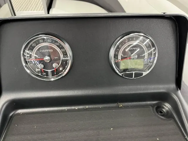 Slide: The Image of Dashboard gauges of 2024 Harris Cruiser 210 boat, displaying speedometer and tachometer. - 13