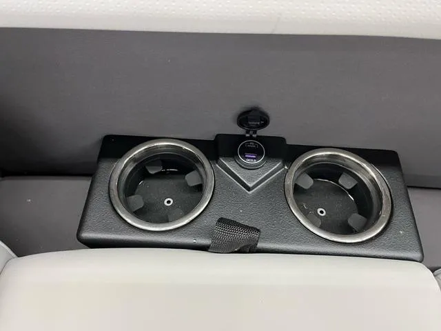 Slide: The Image of 2024 Harris Cruiser 210 cup holders with USB port on boat interior. - 14