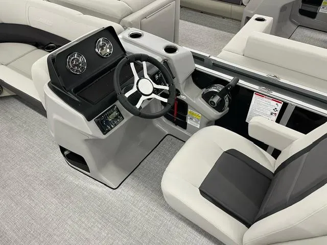 Slide: The Image of 2024 Harris Cruiser 210 boat interior with modern steering console and comfortable seating. - 15