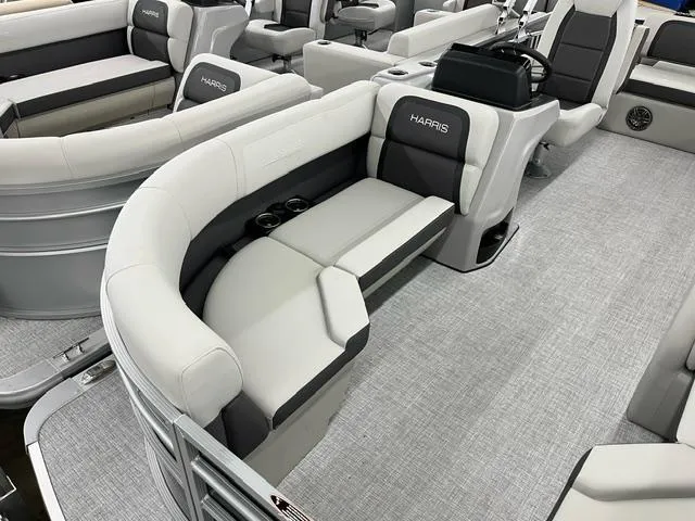 Slide: The Image of 2024 Harris Cruiser 210 pontoon boat interior with gray seating and modern design. - 2