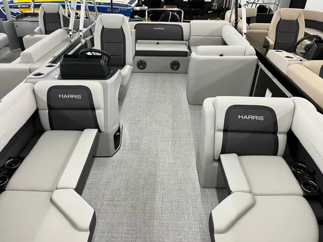 Slide: The Image of 2024 Harris Cruiser 210 pontoon boat interior with gray seating and modern design. - 4