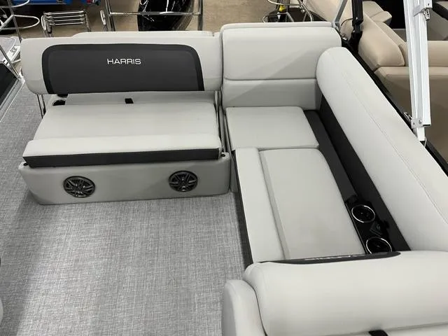 Slide: The Image of 2024 Harris Cruiser 210 interior with gray seating and built-in speakers. - 5