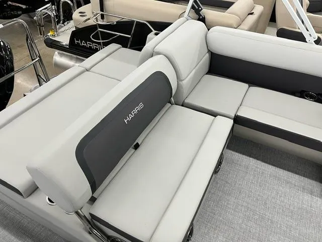 Slide: The Image of 2024 Harris Cruiser 210 boat interior with gray seating and Harris branding. - 6