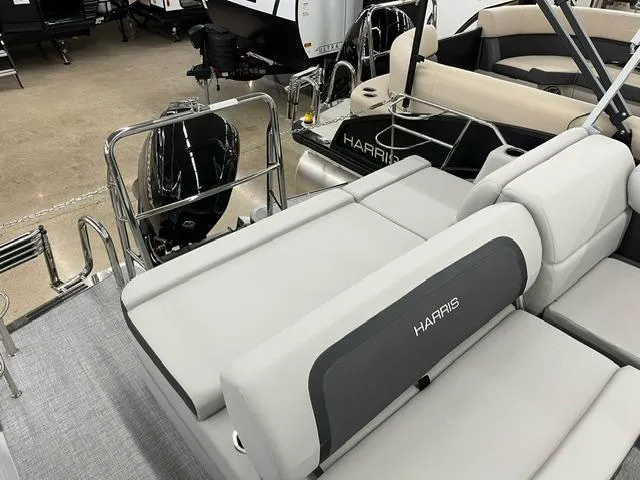 Slide: The Image of 2024 Harris Cruiser 210 boat interior with gray seating and motor. - 7