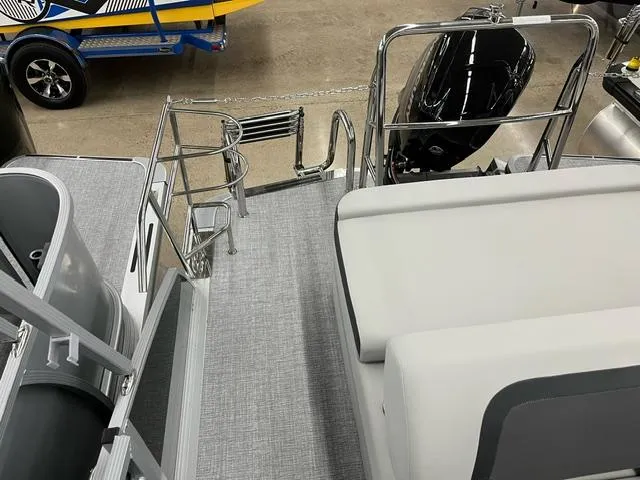 Slide: The Image of 2024 Harris Cruiser 210 boat interior with seating and motor, showcasing sleek design. - 9