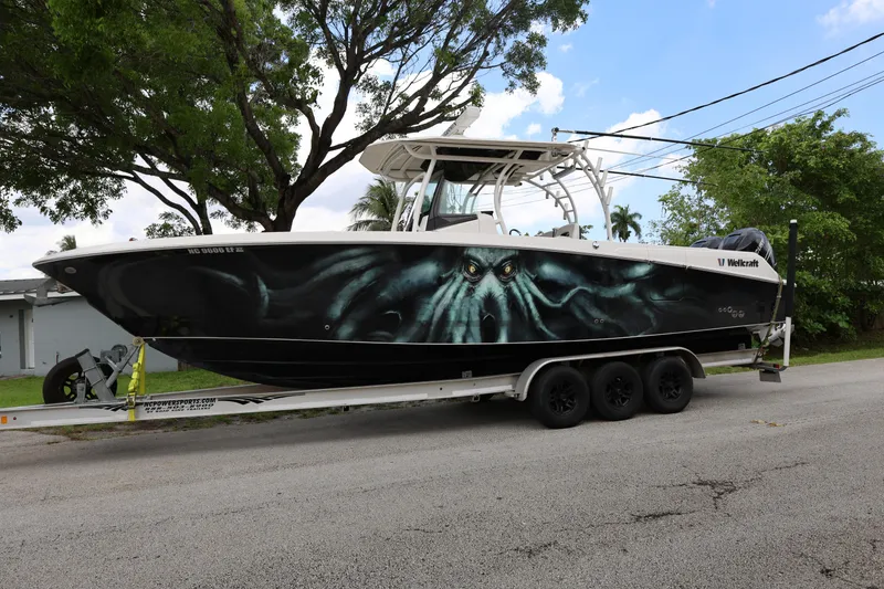 Slide: The Image of 2017 Wellcraft Scarab 302 Fisherman boat with custom octopus design on trailer. - 1
