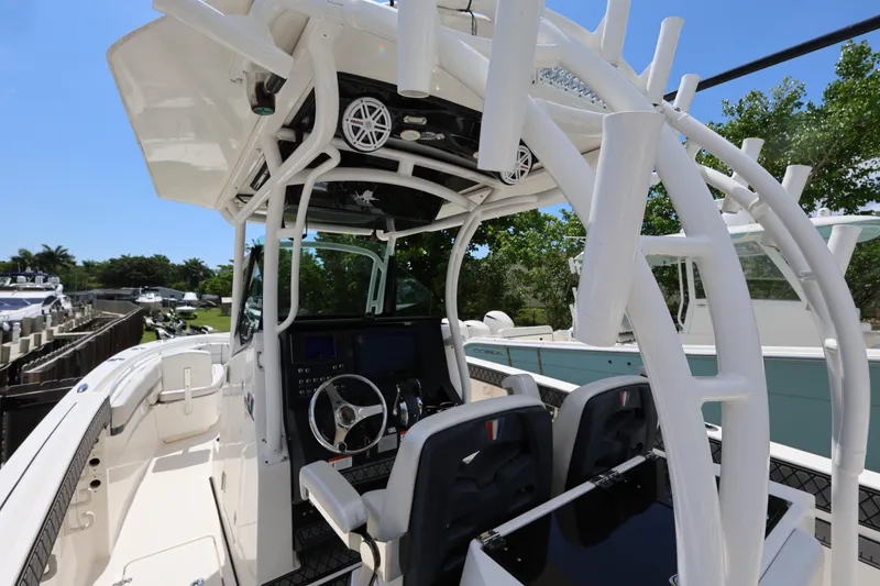 Slide: The Image of 2017 Wellcraft Scarab 302 Fisherman boat cockpit with steering wheel and seating. - 11