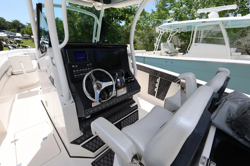 Slide: The Image of 2017 Wellcraft Scarab 302 Fisherman boat interior with steering console and seating. - 14