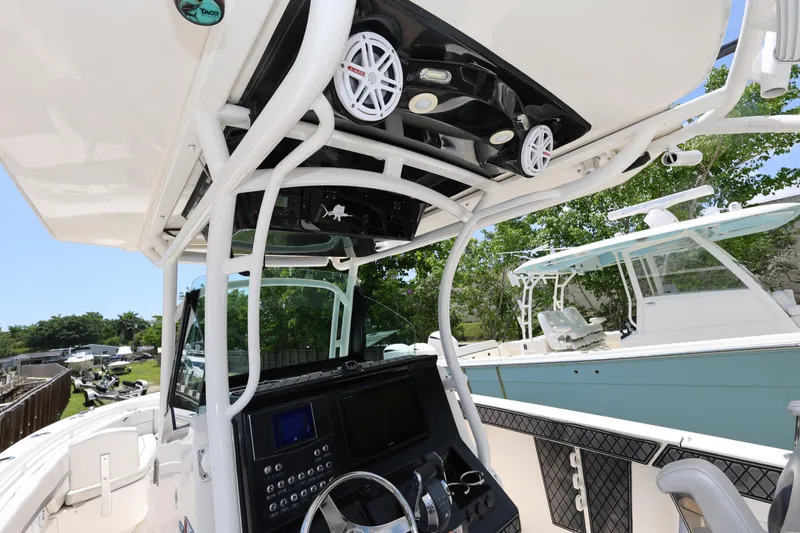 Slide: The Image of 2017 Wellcraft Scarab 302 Fisherman boat console with electronics and steering wheel. - 15