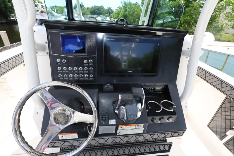 Slide: The Image of 2017 Wellcraft Scarab 302 Fisherman dashboard with steering wheel and electronic controls. - 16