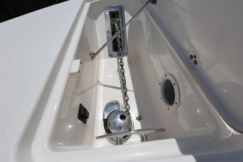 Slide: The Image of Anchor compartment of 2017 Wellcraft Scarab 302 Fisherman boat, featuring chain and winch. - 20