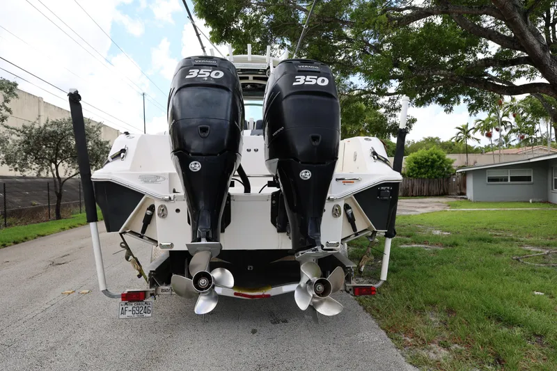 Slide: The Image of 2017 Wellcraft Scarab 302 Fisherman with twin 350 horsepower engines, parked on a residential street. - 4
