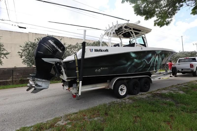 Slide: The Image of 2017 Wellcraft Scarab 302 Fisherman boat on trailer, parked on roadside. - 6