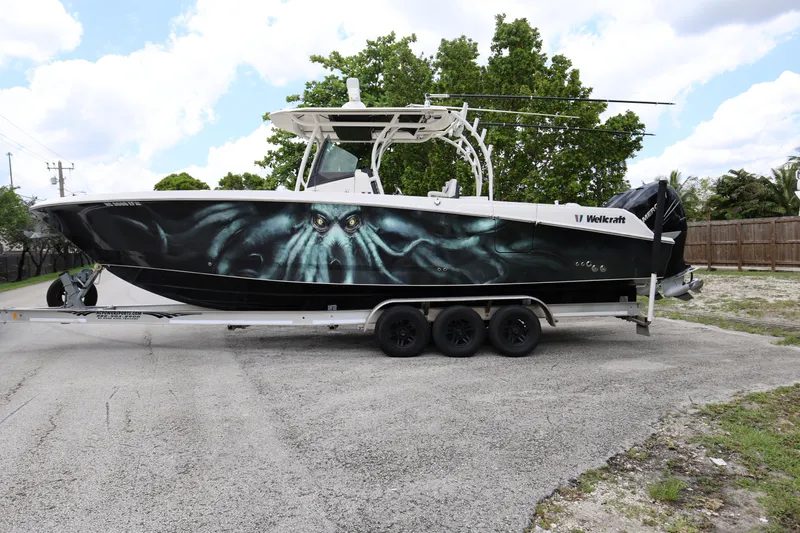 Slide: The Image of 2017 Wellcraft Scarab 302 Fisherman boat with custom octopus design on trailer. - 8
