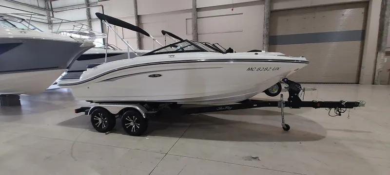 The Image of 2023 Sea Ray SPX 190 boat on trailer in indoor showroom. - 0