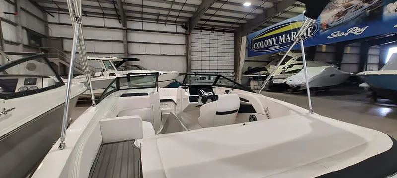 Slide: The Image of 2023 Sea Ray SPX 190 boat interior in showroom, featuring sleek design and comfortable seating. - 15