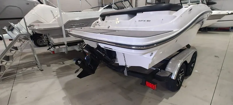 Slide: The Image of 2023 Sea Ray SPX 190 boat on trailer in showroom. - 5
