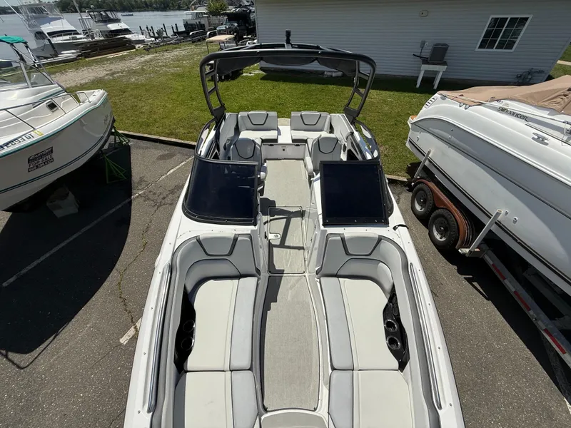 Slide: The Image of 2022 Yamaha Boats AR250 with spacious seating, docked in a marina. - 15