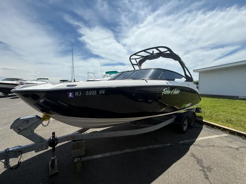 Slide: The Image of 2022 Yamaha Boats AR250 on trailer, parked outdoors under a partly cloudy sky. - 3