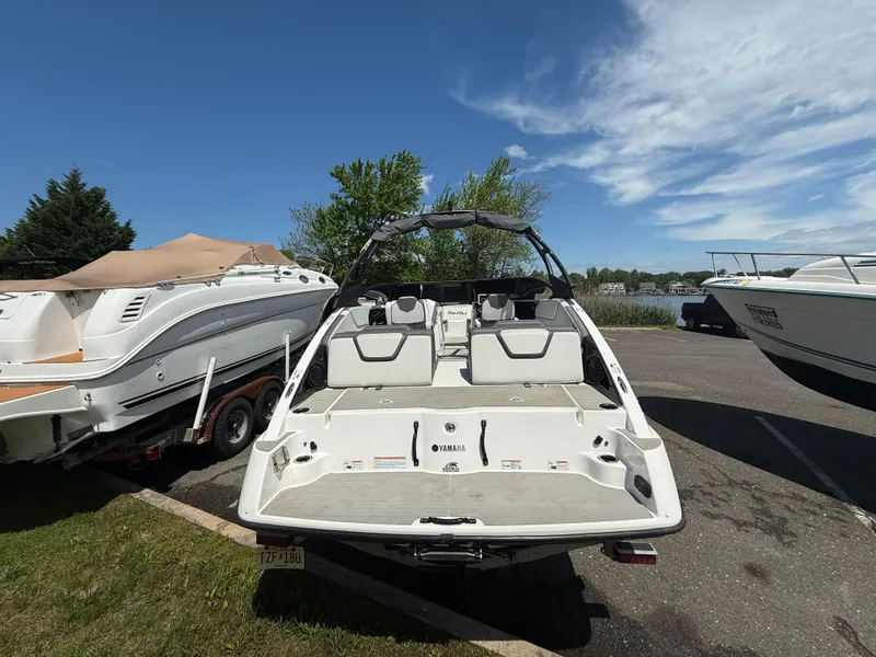 Slide: The Image of 2022 Yamaha Boats AR250 parked on a sunny day near a lake. - 6