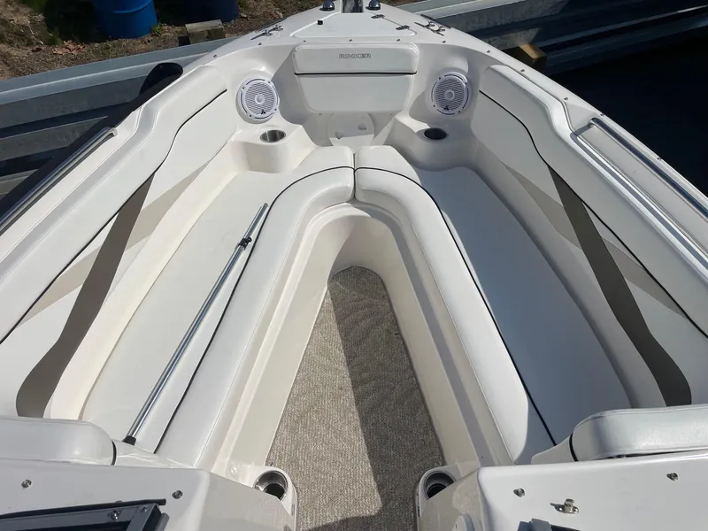 Slide: The Image of 2007 Rinker 282 Captiva Bowrider interior with white seating and speakers. - 3