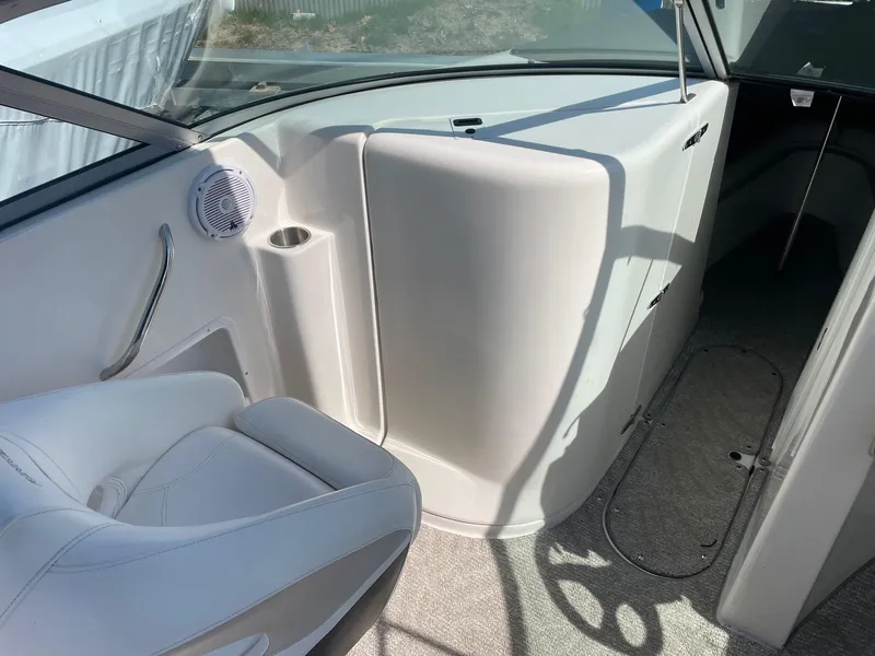 Slide: The Image of 2007 Rinker 282 Captiva Bowrider interior with white seating and speaker. - 5