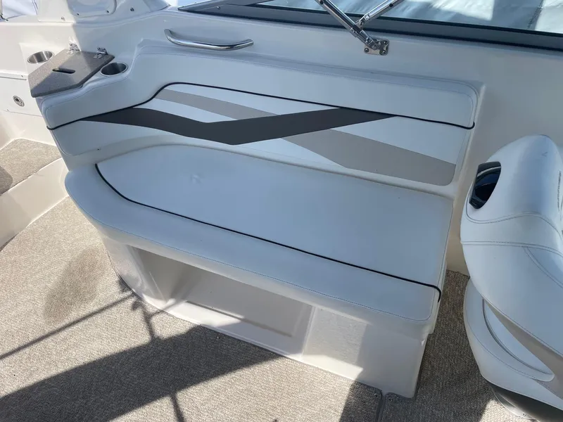 Slide: The Image of 2007 Rinker 282 Captiva Bowrider interior seating with white and gray upholstery. - 6
