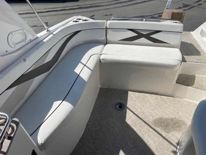 Slide: The Image of 2007 Rinker 282 Captiva Bowrider interior seating with white upholstery and stylish design. - 7