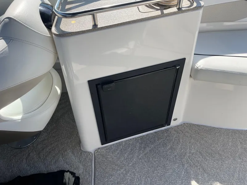 Slide: The Image of 2007 Rinker 282 Captiva Bowrider interior with seating and storage compartment. - 8